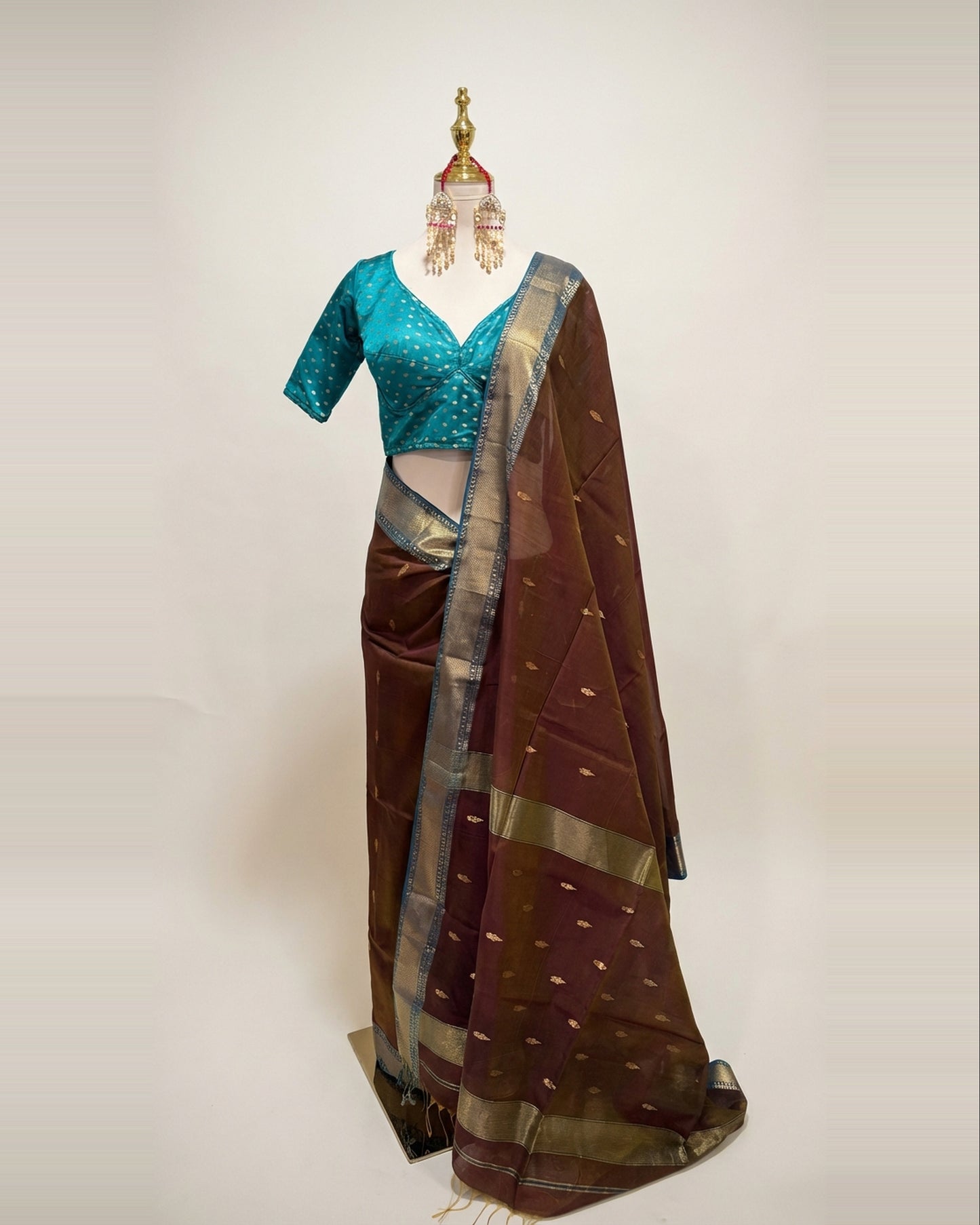 Handwoven Maheshwari silk cotton saree in coffee color and teal border.